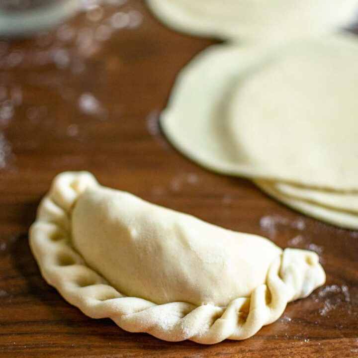Empanada dough that has been filled and shaped.