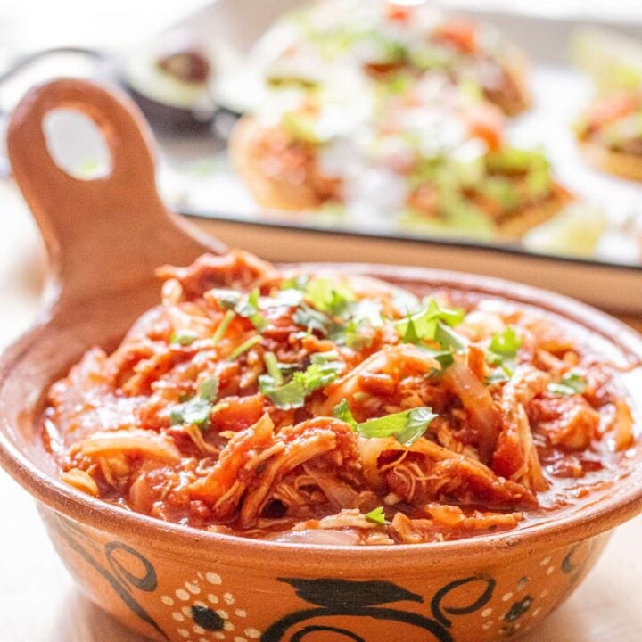 A cazuela or clay pot with Mexican chicken tinga.